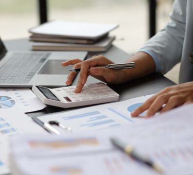 Business woman accountant working in office checking financial accounts and allocating company budgets