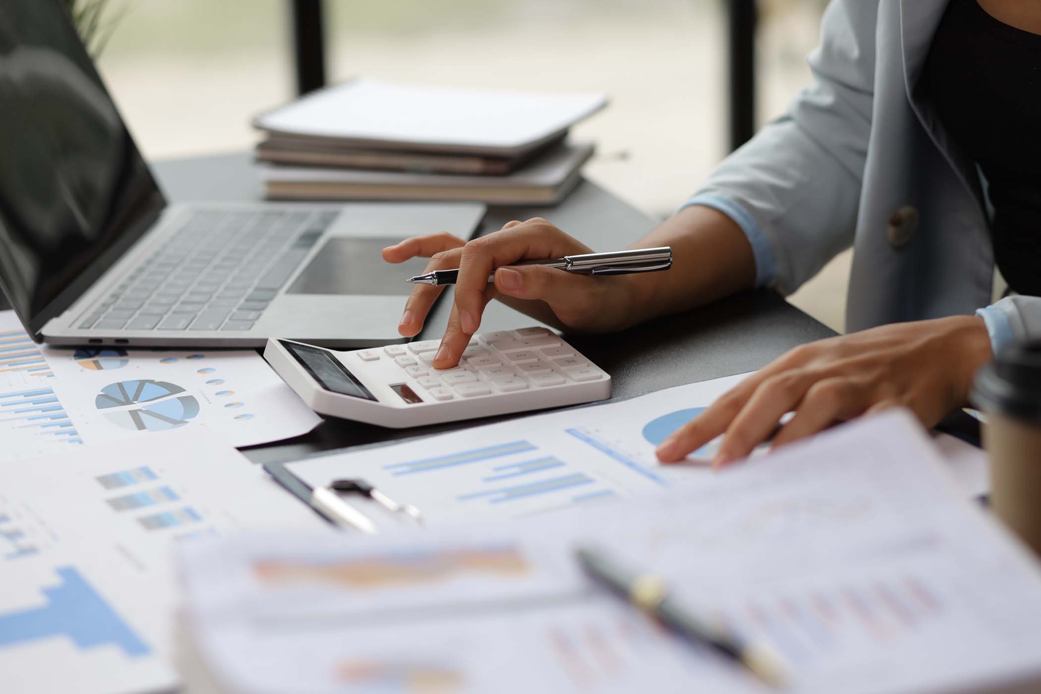 Business woman accountant working in office checking financial accounts and allocating company budgets